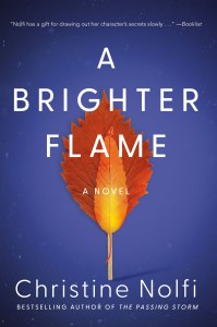 A BRIGHTER FLAME by Christine Nolfi book cover, blue background with a large orange-red leaf behind a orange-yellow thin leaf mimicking a flame