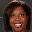 Patti Flinn author headshot; close-up photograph of a smiling Black woman with brown shoulder-length hair.