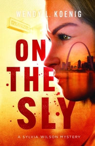 ON THE SLY by Wendy L Koenig book cover featuring a profile view along the right side of the cover of a white female with dark brown hair, superimposed over her face is a view of the St. Louis Gateway Arch and the Mississippi River; the left side of the cover features the title in all caps