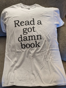 White t-shirt with "Read a got damn book"